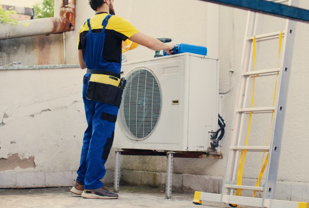 HVAC technician servicing air conditioning unit on rooftop, emphasizing maintenance for optimal airflow in Cookeville and Sparta homes.